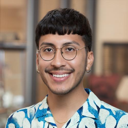 Guillermo Alvarado wearing a patterned shirt and glasses.