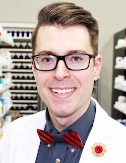 Benjamin McNabb in glasses and a bowtie smiling.