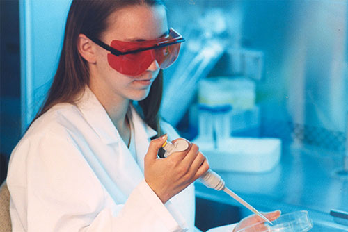 Student researcher in lab with blue background