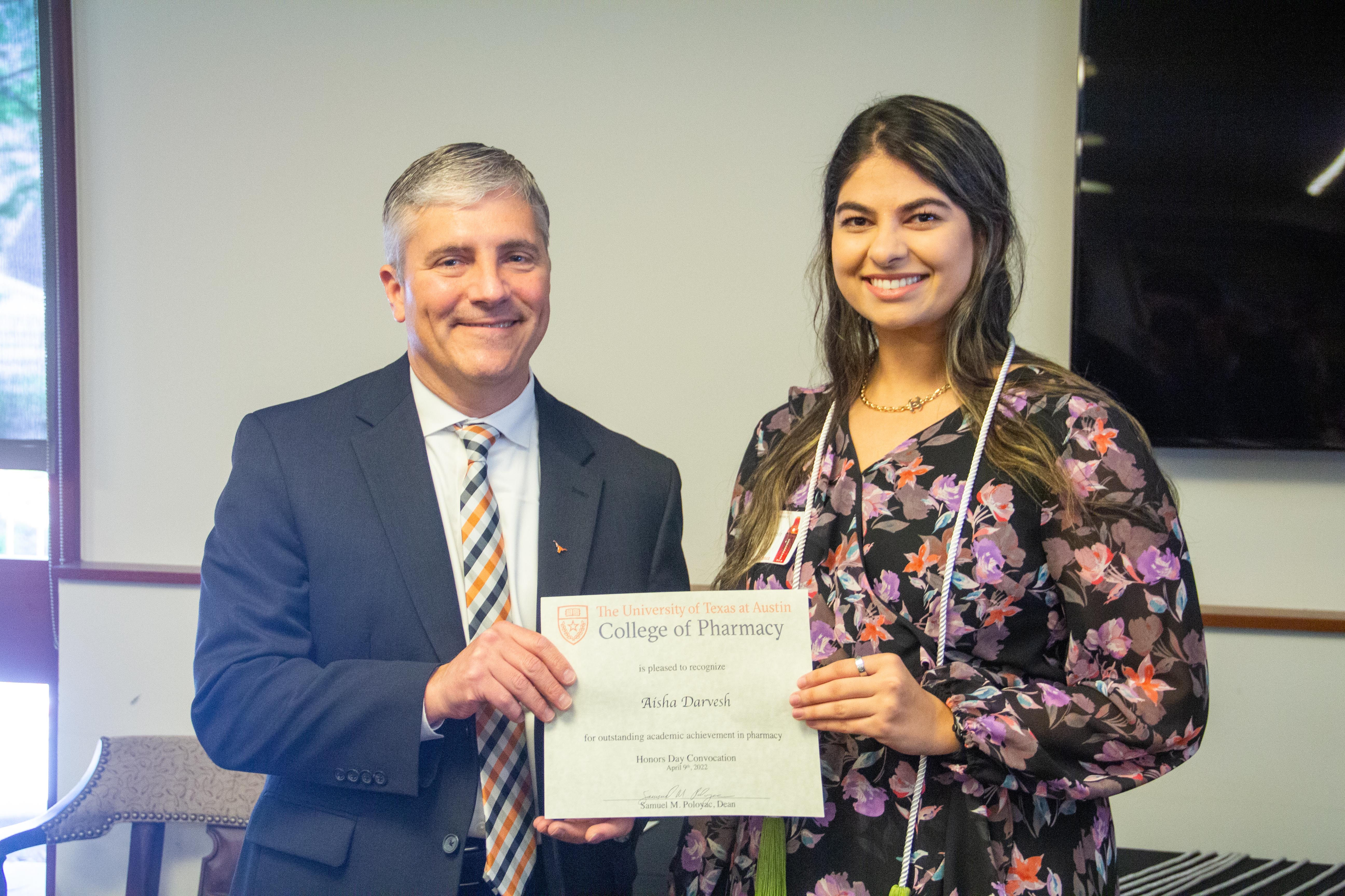 Aisha and Dean Poloyac with award certificate.