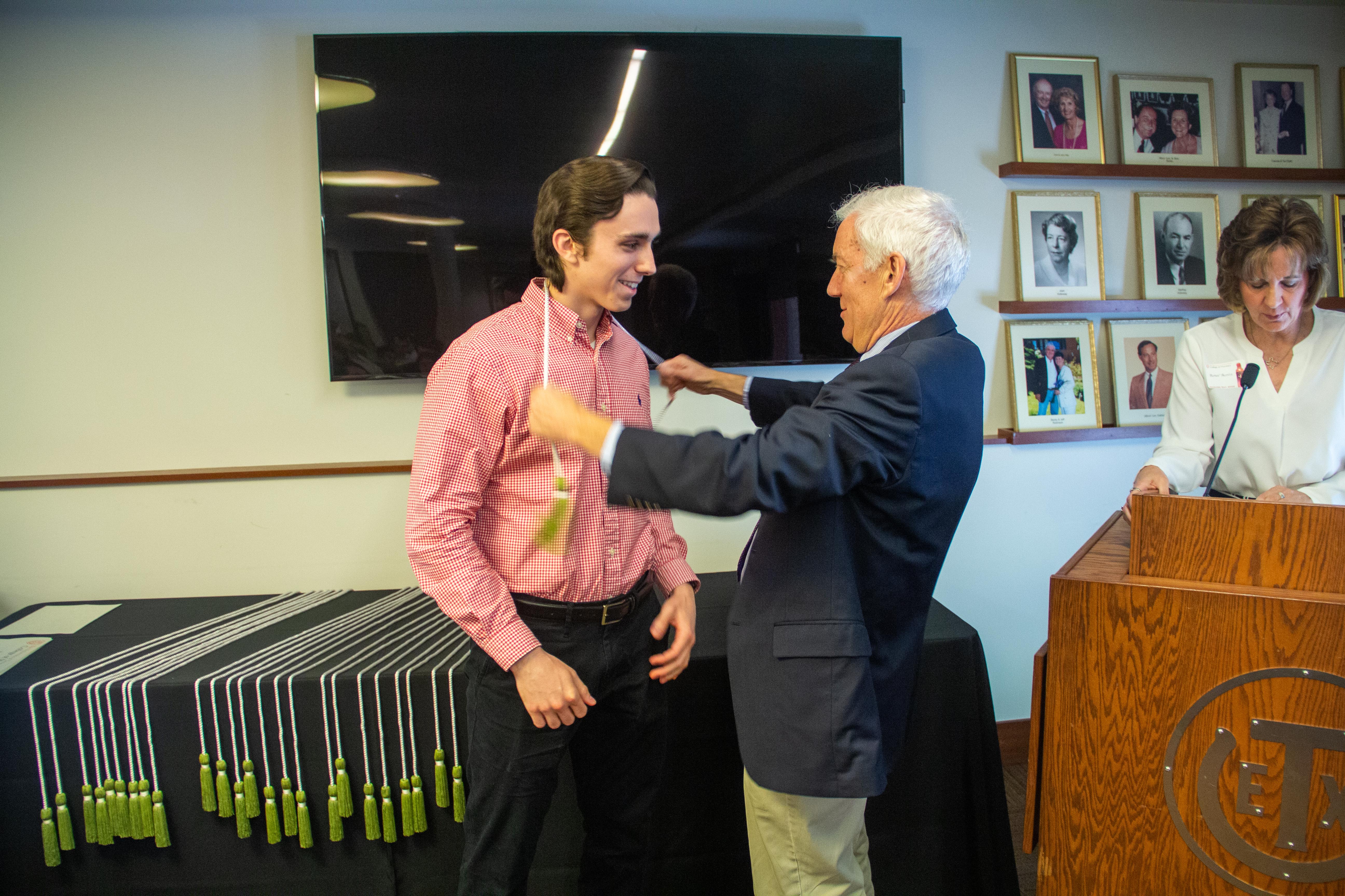 Chad receiving his honor cords from Dr. Whitman.