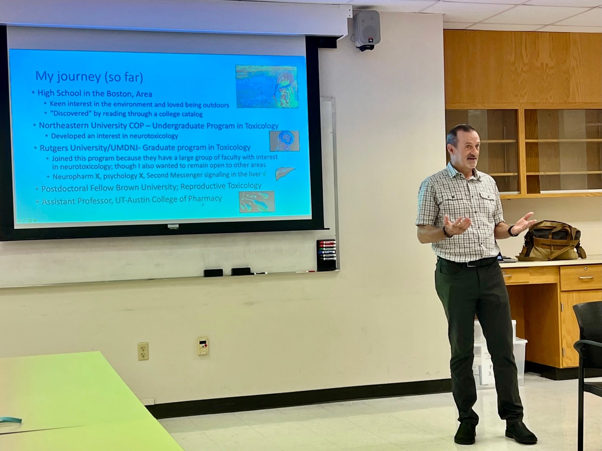 Dr. Richburg lecturing to group in front of a screen.