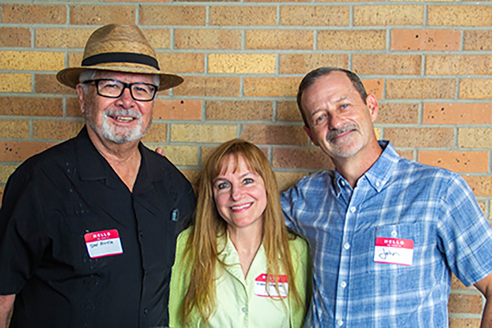 Dr. Daniel Acosta, Dr. Karen Vasquez, and Dr. John Richburg smiling and standing in front of brick wall at PharmTox meet and greet event