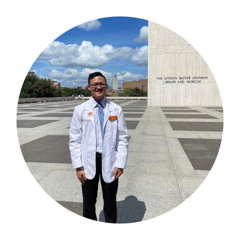 Student Pharmacist Anthony Wang poses wearing his white coat.