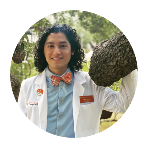 Student Pharmacist Alfredo wearing a white coat and orange bowtie.