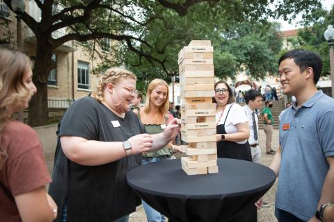 Student pharmacist Hannah McCullough at a New Student Orientation event playing Jenga with colleagues.