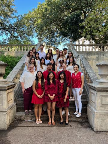 Student pharmacist and KE president Hannah M. with KE members on steps outside Pharmacy building.