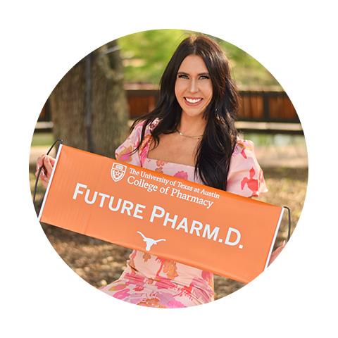 A woman wearing a dress and holding a "Future Pharm.D." sign.