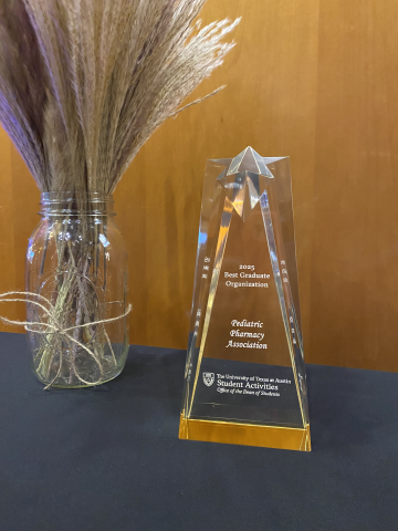 An picture of the PPA Best Graduate Student Award. The trophy is clear glass with a star on the top.