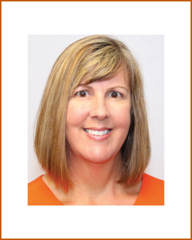 A headshot of Debbie Garza. Debbie has a light brown bob and is smiling brightly to camera in an orange tshirt.