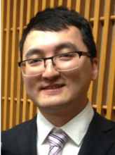 A headshot of Dr. Yang. He has short brown hair and is wearing dark-rimmed rectangular glasses.