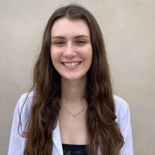 Sarah Radke smiling and wearing a white coat