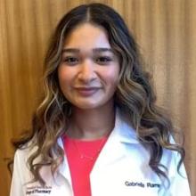 Gabriella Ramirez smiling and wearing a white coat
