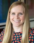 Dr. Kelli Sims smiling and wearing a floral top