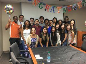 Group photo of APPE students standing under banner that reads, "Congrats"