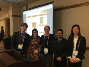 Members of Williams lab standing in front of projector screen