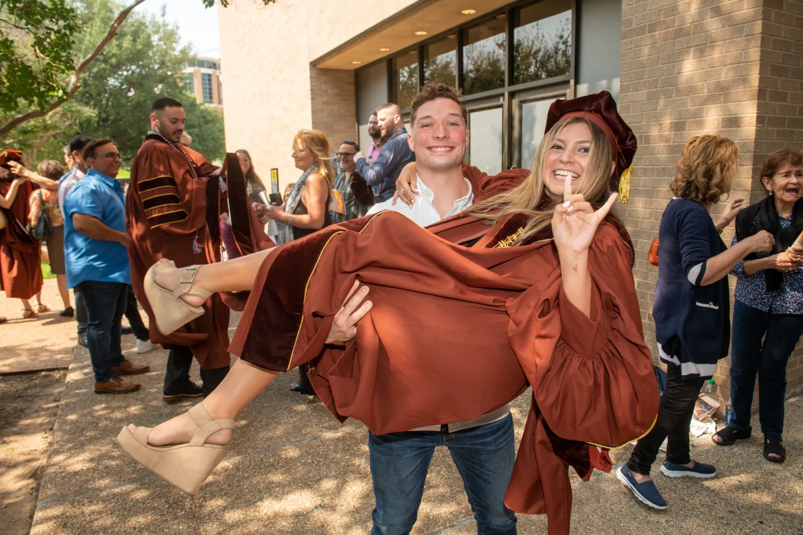 A graduate celebrating with a family member.