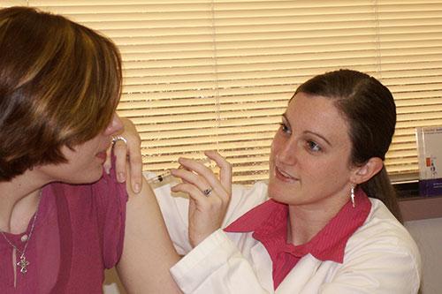 Resident administering vaccine