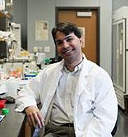 Dr. Som Mukhopadhyay seated in lab