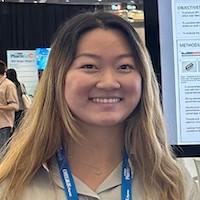 Angela Ren smiling while wearing a lanyard.