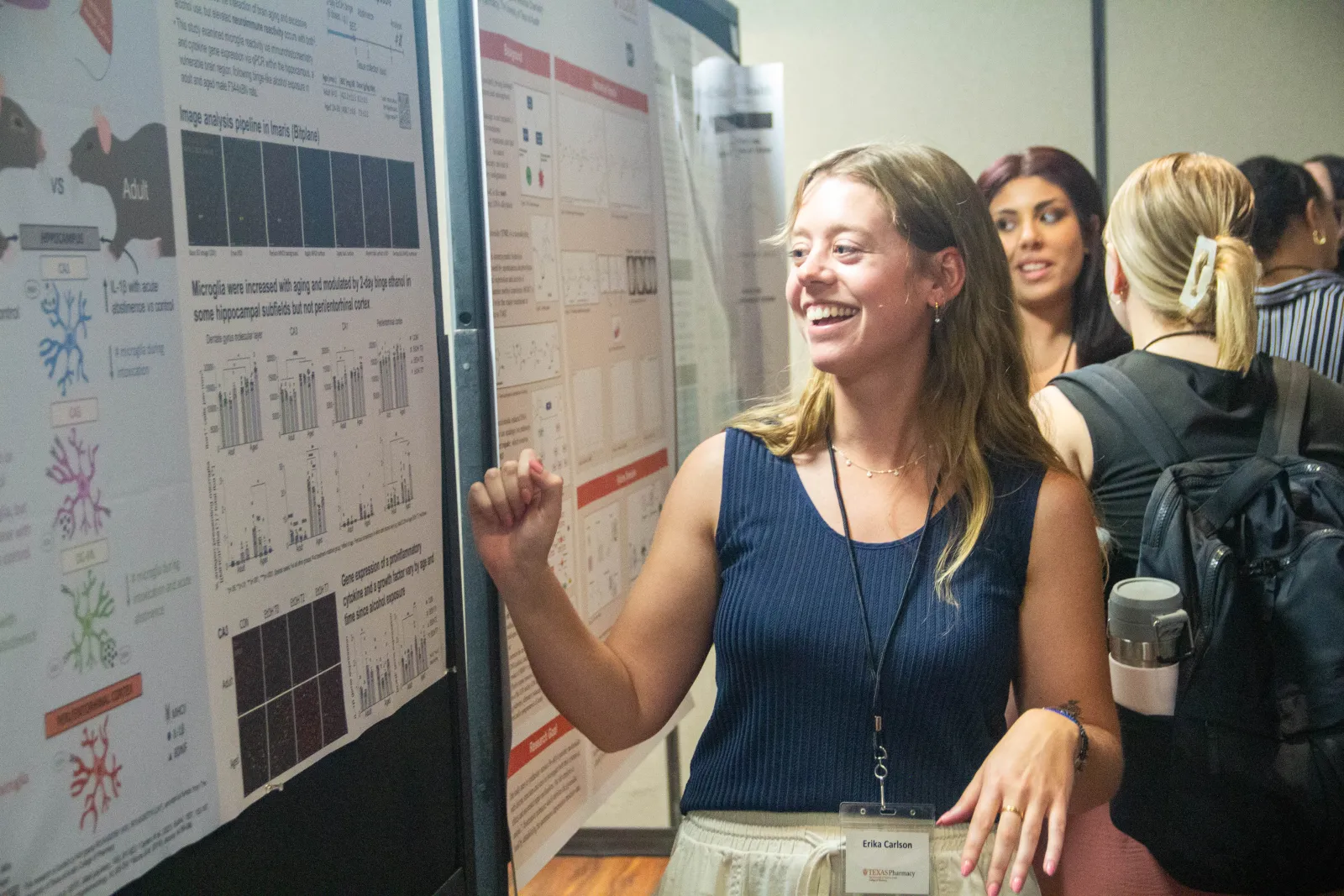 A woman looking at a poster presentation.