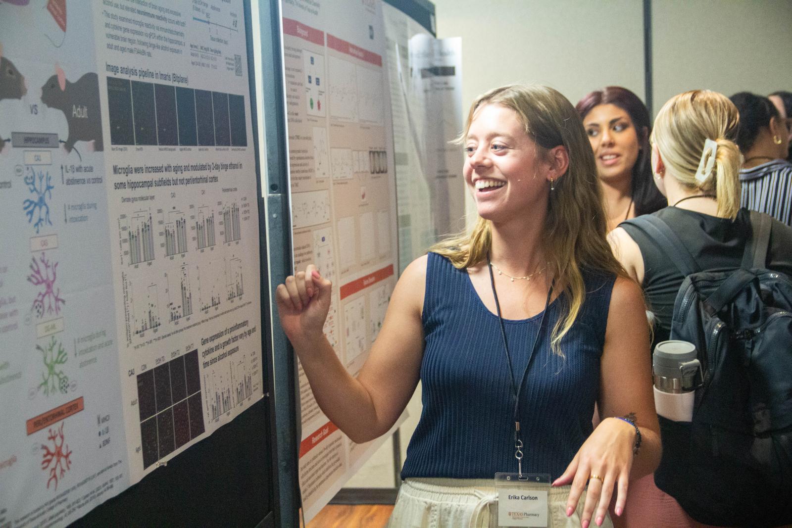 A woman looking at a poster presentation.