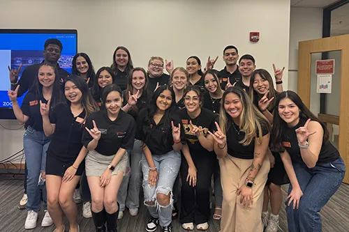 Group photo of Pharmacy Ambassadors giving hook em horns sign
