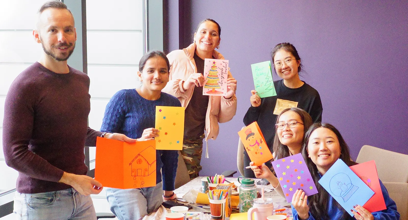 PharmTox graduate students making cards at a Thanksgiving potluck event