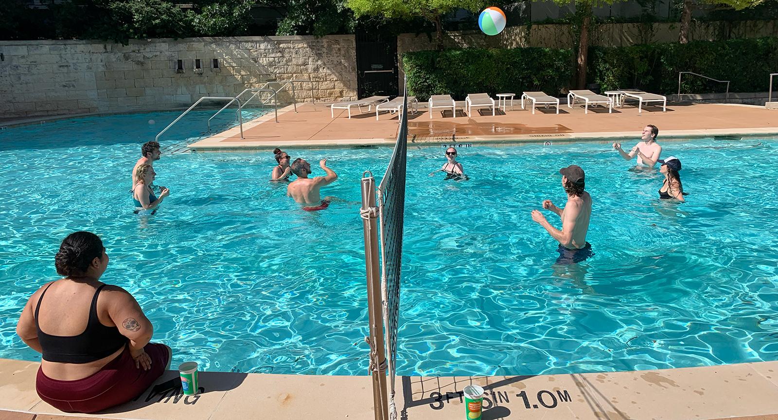 PharmTox graduate students playing volleyball in a swimming pool