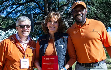 Three alumni tailgate event awardees dressed in burnt orange