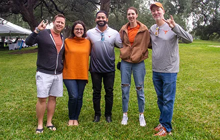 Five smiling attendees at the 2023 Alumni Homecoming Tailgate