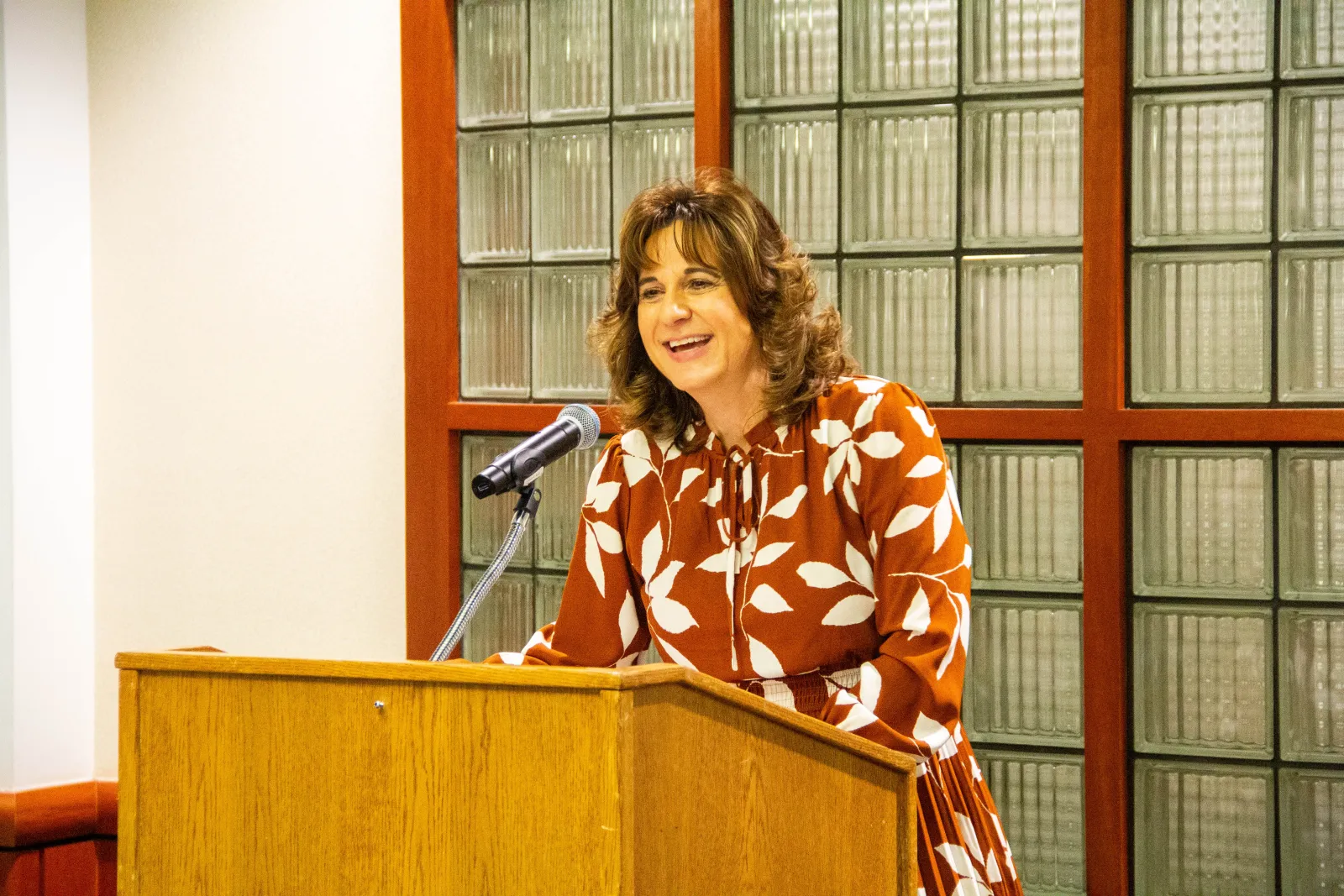Senior Associate Dean for Academic Affairs Renee’ Acosta addressing the room as the Master of Ceremonies.