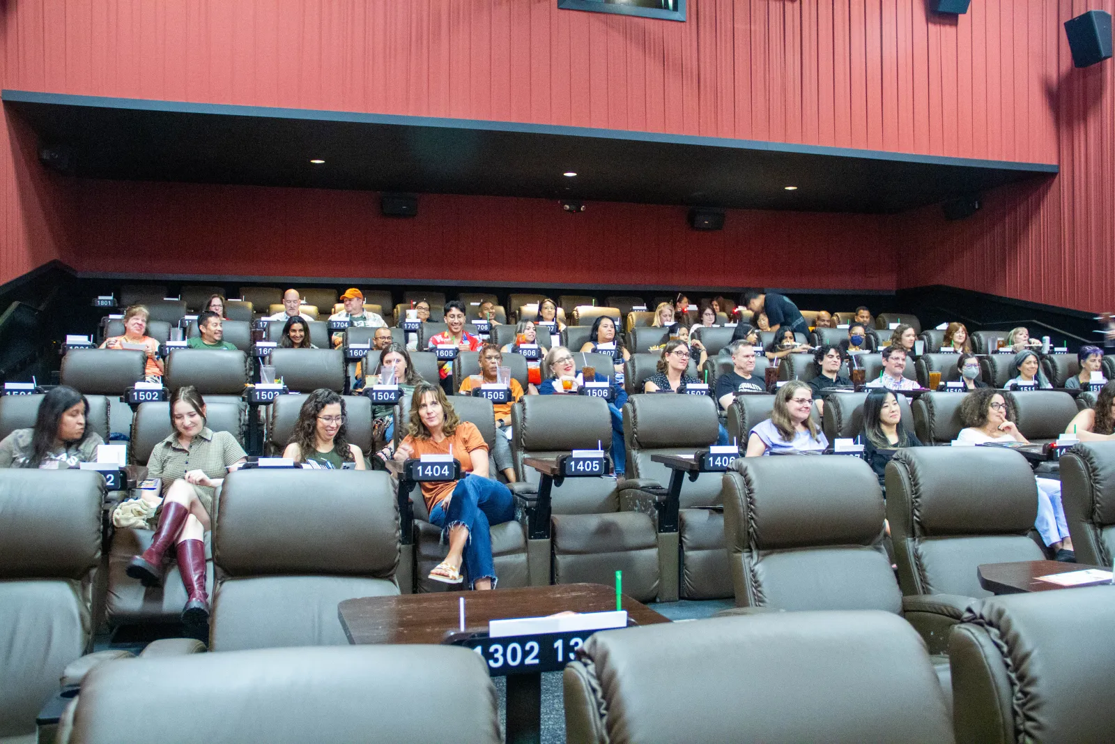 Texas Pharmacy staff sitting in a movie theatre before the show.