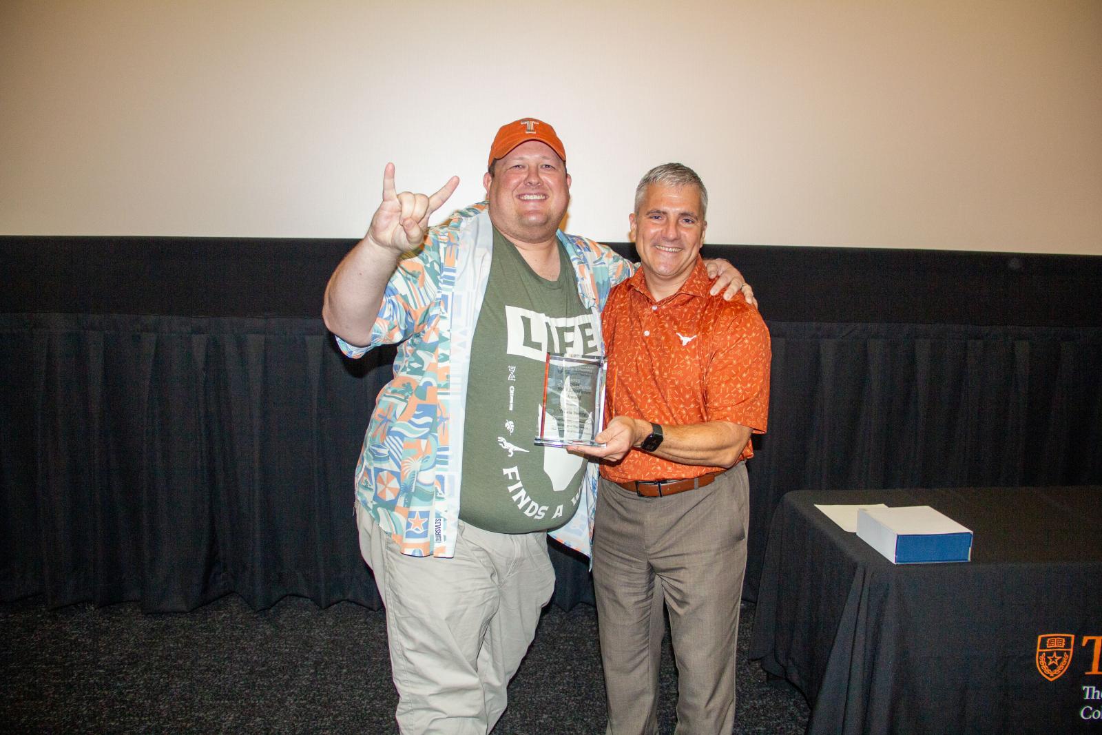 Travis Henry receiving his award from Dean Poloyac.