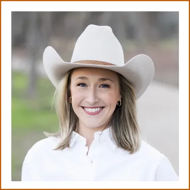 Headshot of Dr. Cathleen McCormack. Dr. McCormack is wearing a white button-up blouse and cream cowboy hat and is smiling to camera.