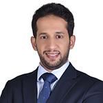 Dr. Ahmed Alsheri smiling in an indoor setting