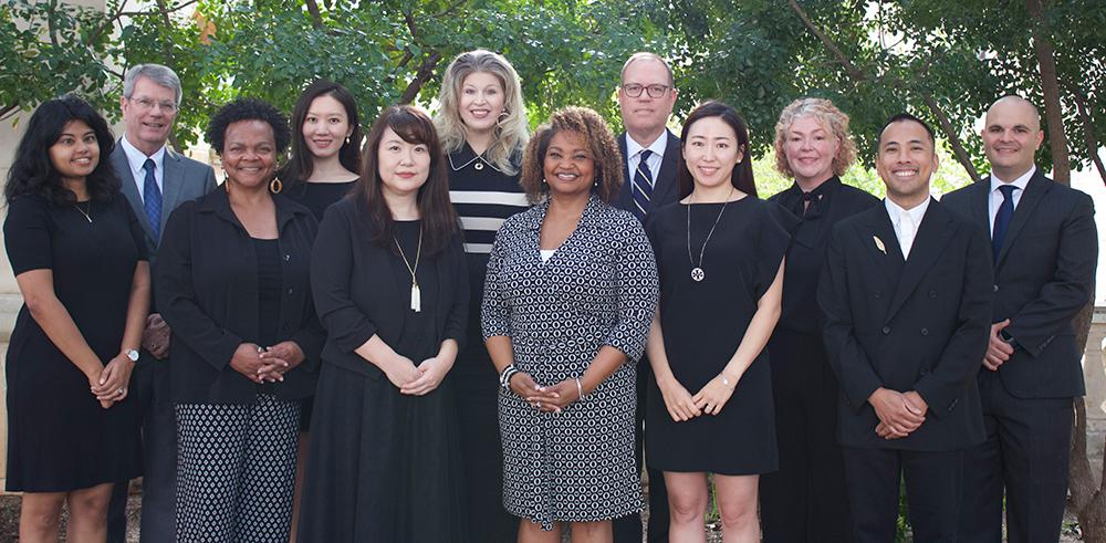 Group photo of Health Outcomes division faculty in an outdoor setting with trees