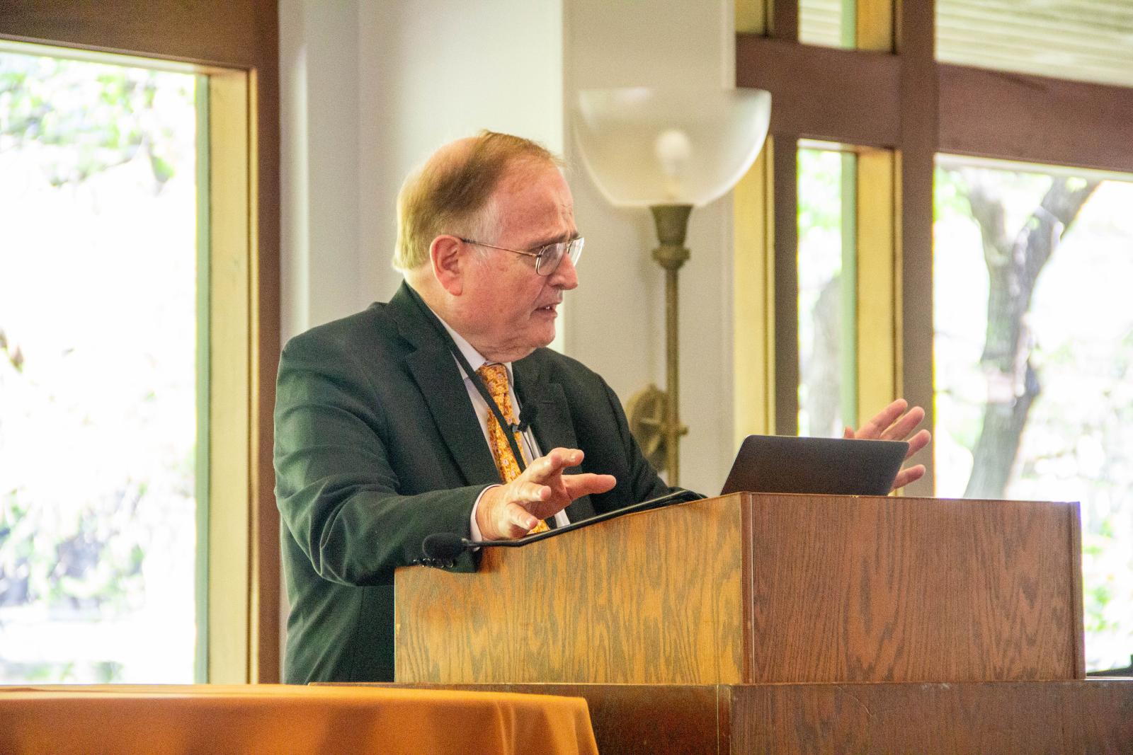A man gesturing at a podium.