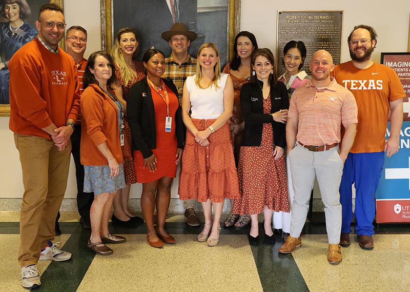 Pharmacotherapy and Translational Sciences division faculty standing in a group and wearing burnt orange