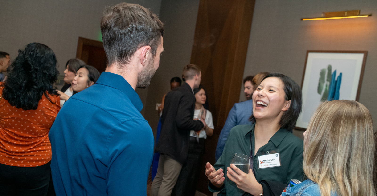 Young professionals in casual conversation at a networking event.