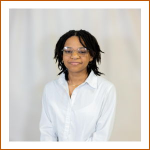 Headshot of student pharmacist Kennedy. She has short, dark hair, wears glasses and a white blouse. She smiles softly to camera.
