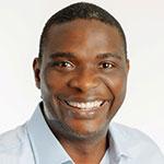 Dr. Abiola Oladapo smiling in an indoor setting