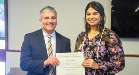 Aisha and Dean Poloyac with award certificate.