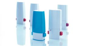 Five nasal inhalers with their caps on.