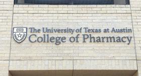 Brick facade of Pharmacy building with affixed text, "The University of Texas at Austin College of Pharmacy"