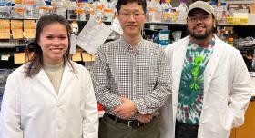 Dr. Lee and research graduate students standing in the Lee Lab.