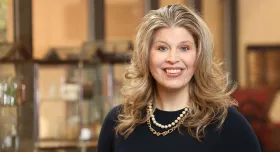 Dr. Moczygemba wearing a necklace and smiling.
