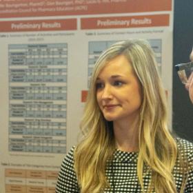 A woman in front of a research poster.