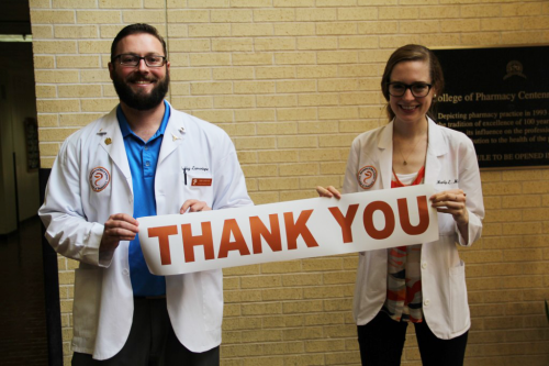 Students holding thank you banner
