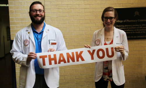 Students holding thank you banner